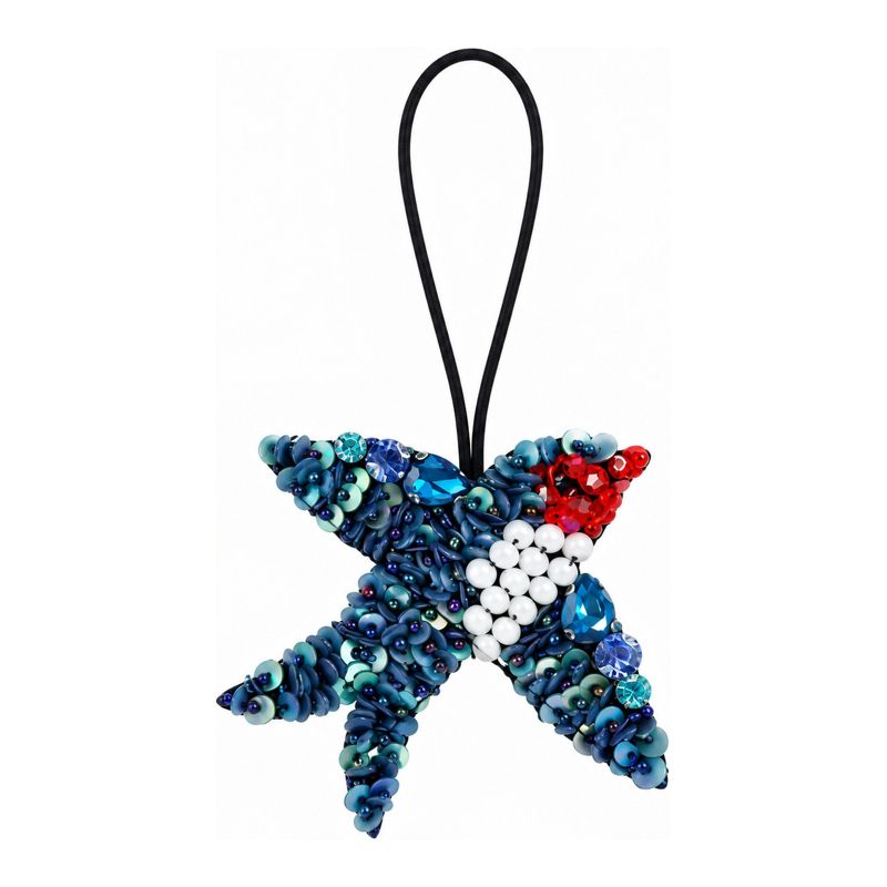Star-shaped beaded charm in blue tones with red and white accents